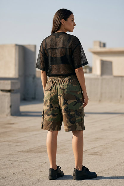 Rear three-quarter lifestyle view of camo cargo shorts styled with the black Shadow Mesh Tee